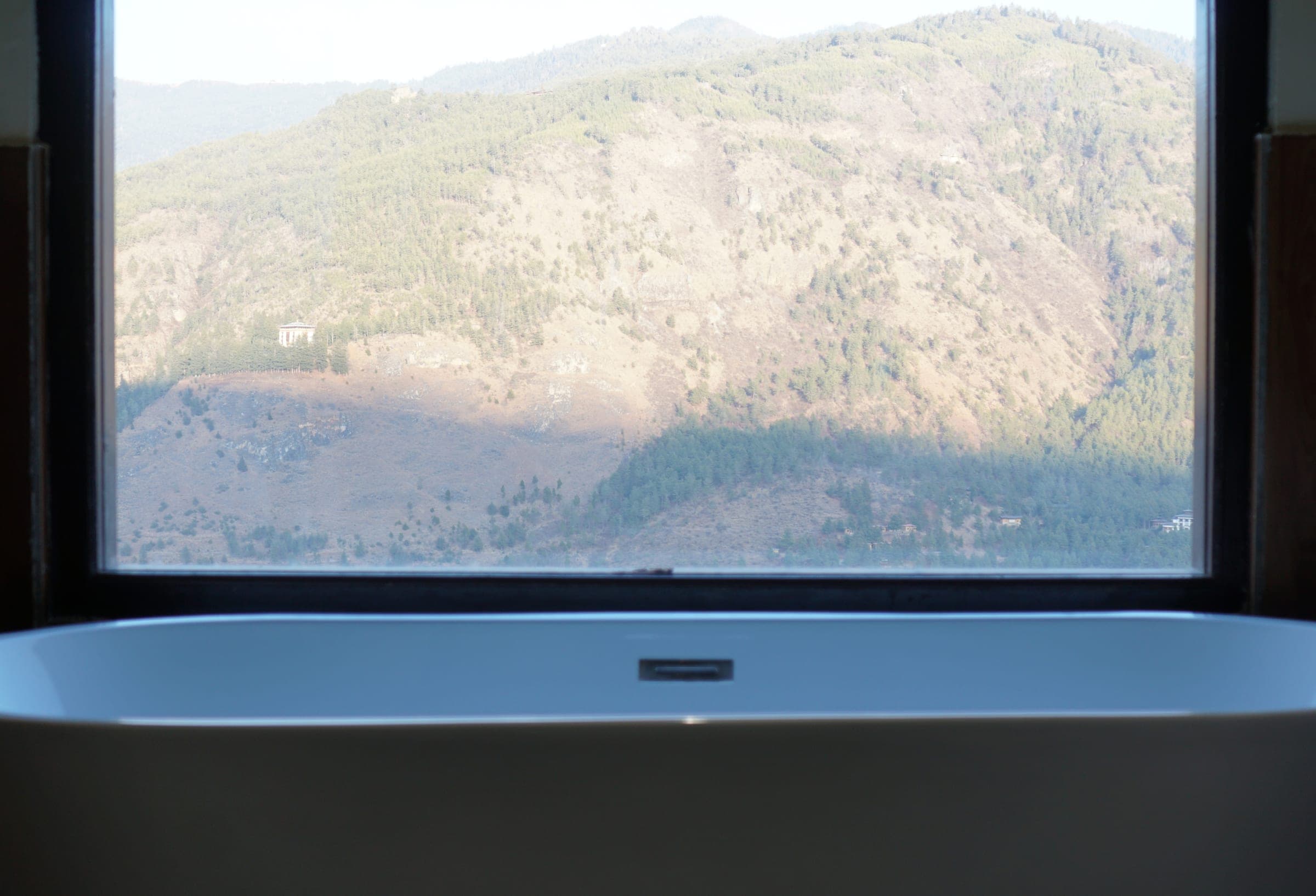 Bathtub with a mountain view inside the Hilltop Deluxe Dome at Zachakha