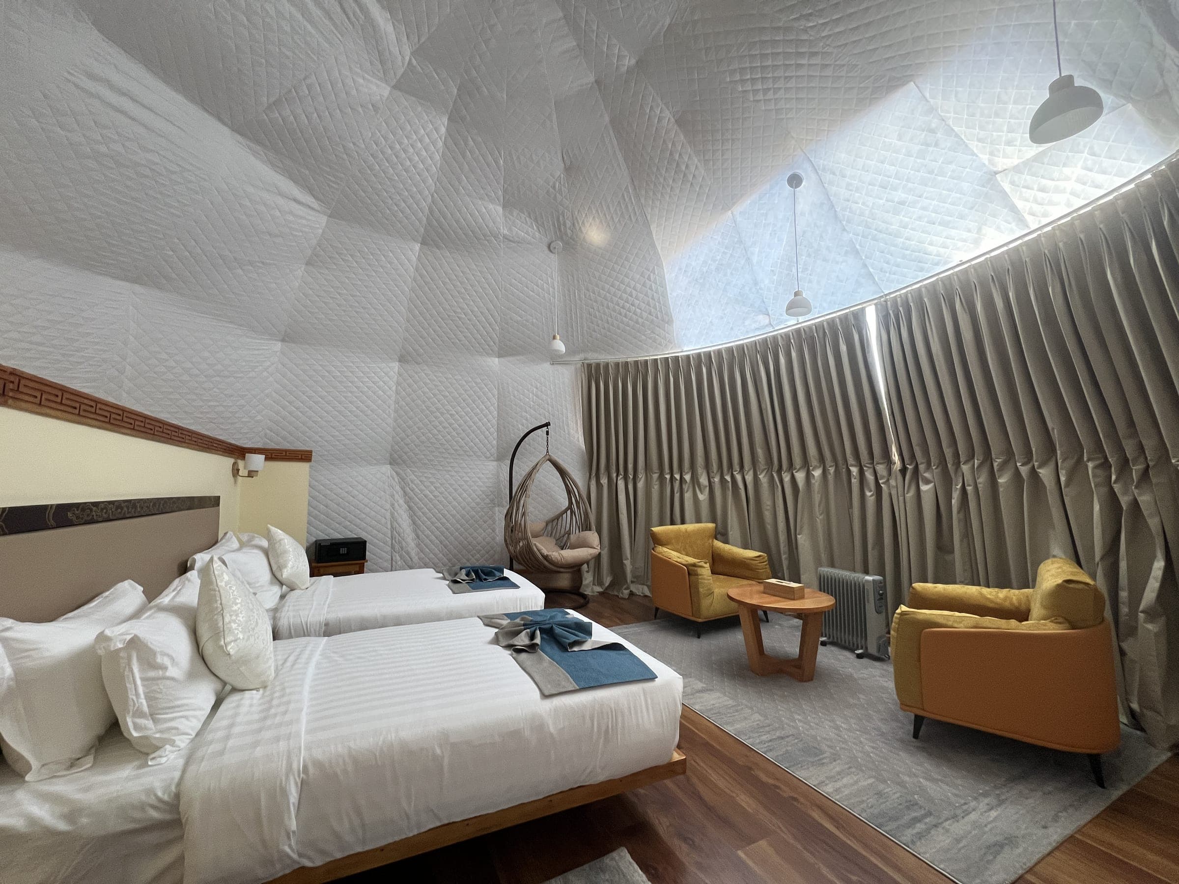 Hilltop Deluxe Dome interior with panoramic window over the Paro valley at Zachakha