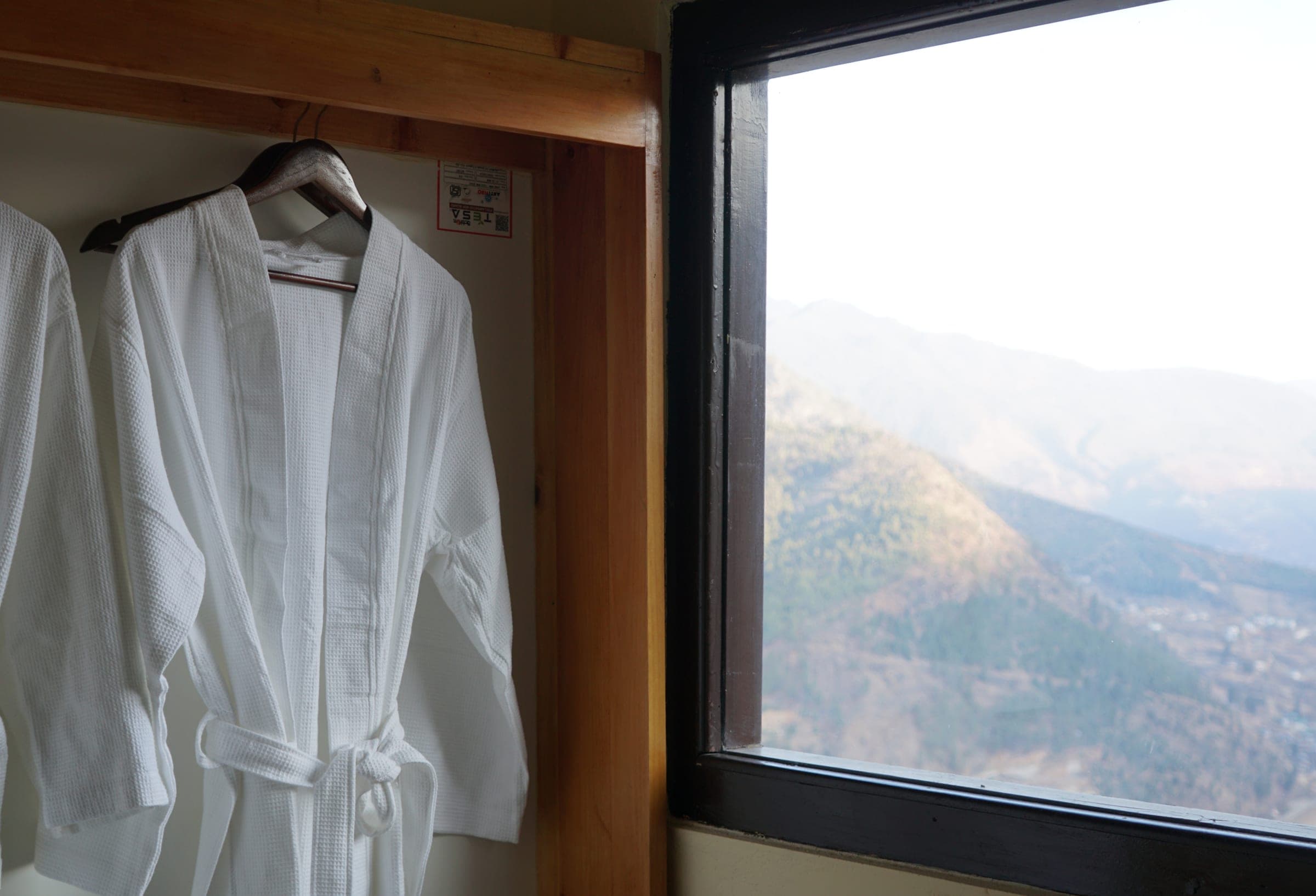 Bathrobes beside the valley-facing window in the Hilltop Deluxe Dome