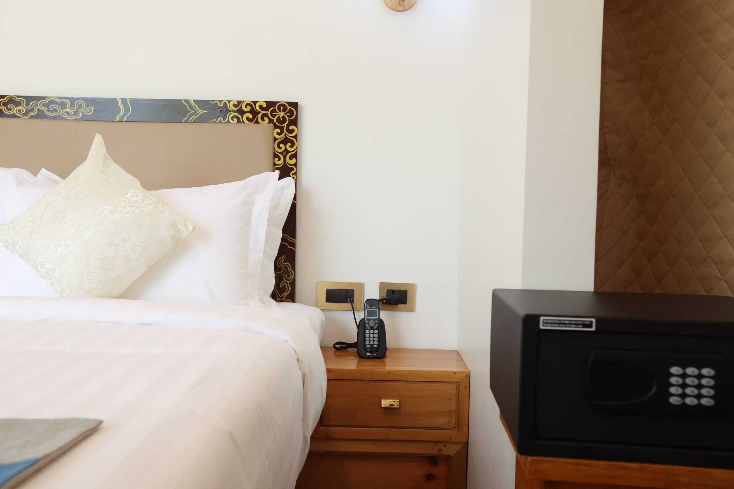 Bedside table and in-room safe in the Superior Deluxe Dome