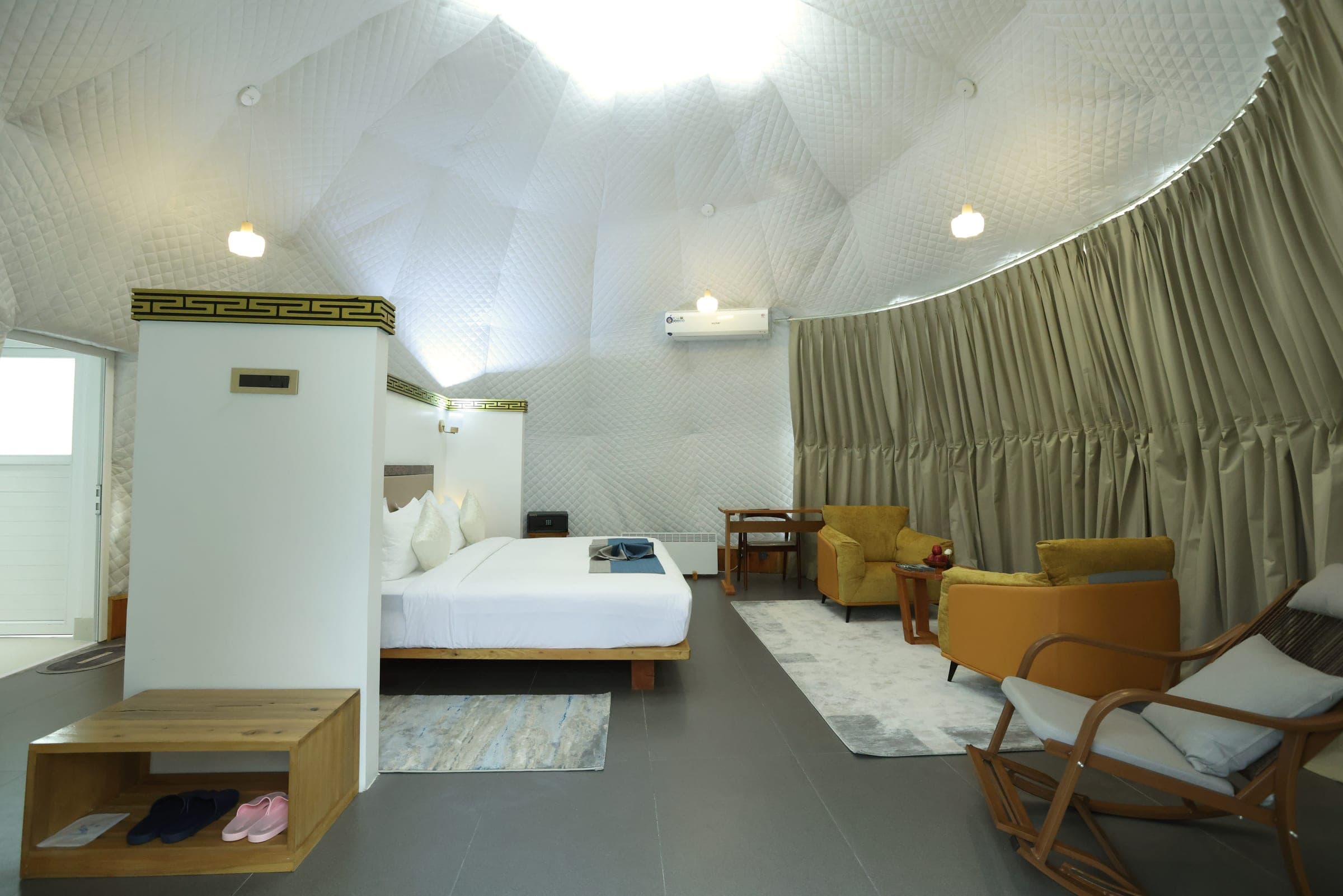 Superior Deluxe Dome interior with king bed and lounge seating at Kepdinkha