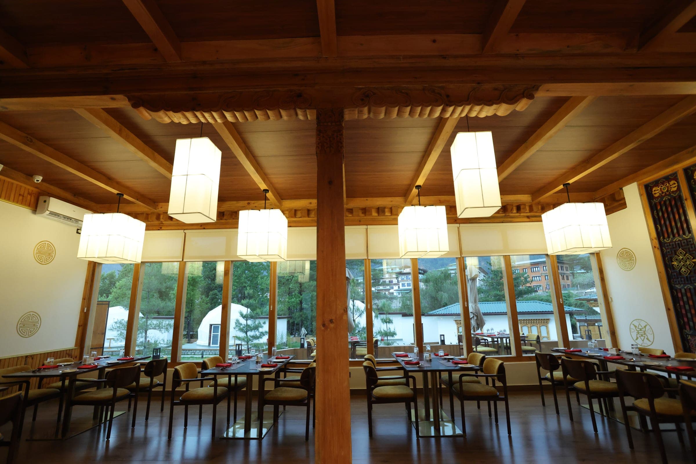 Restaurant interior with warm pendant lanterns at Highland Glamping