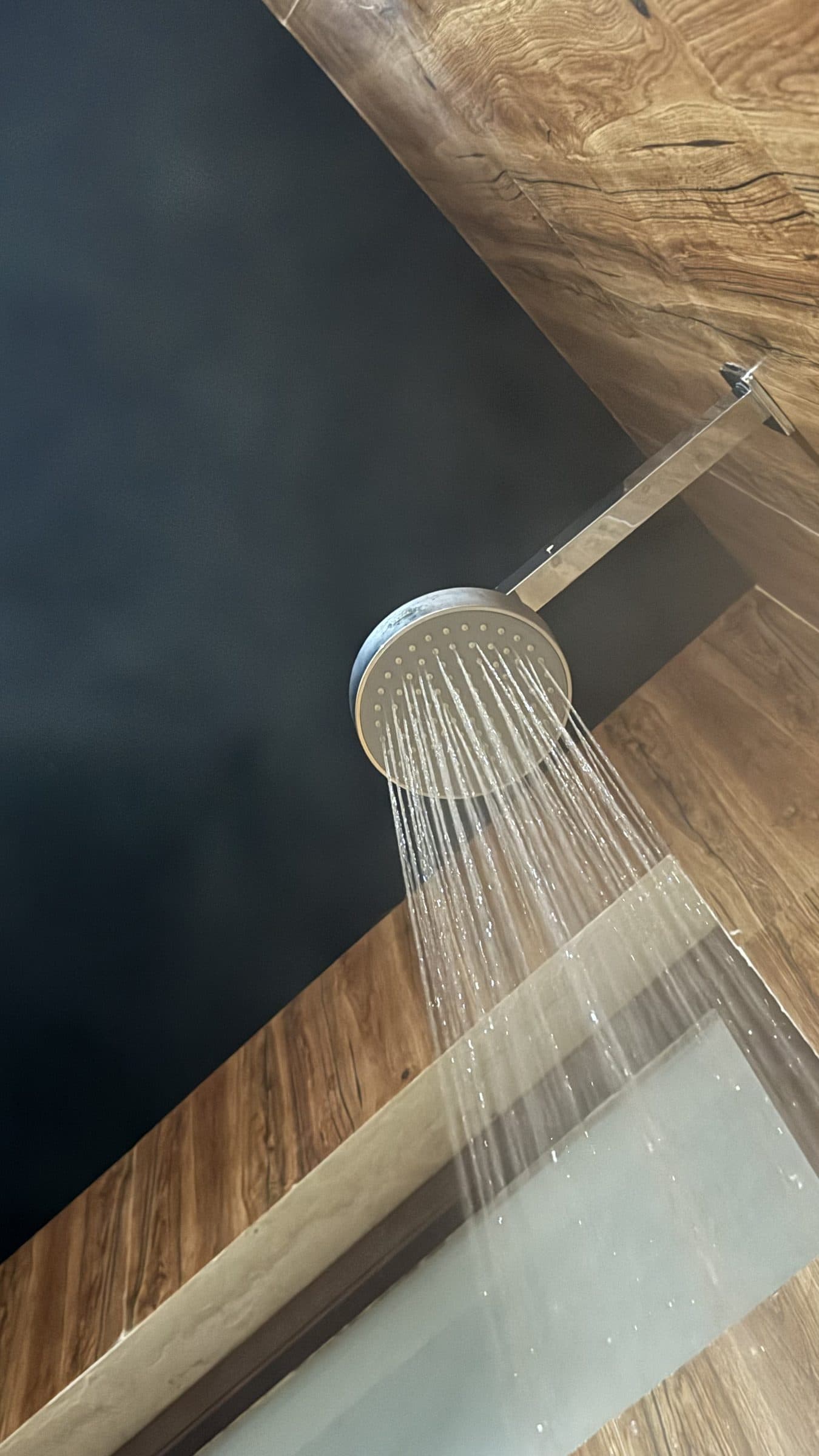 Open-roof rain shower running beneath the night sky at Highland Glamping