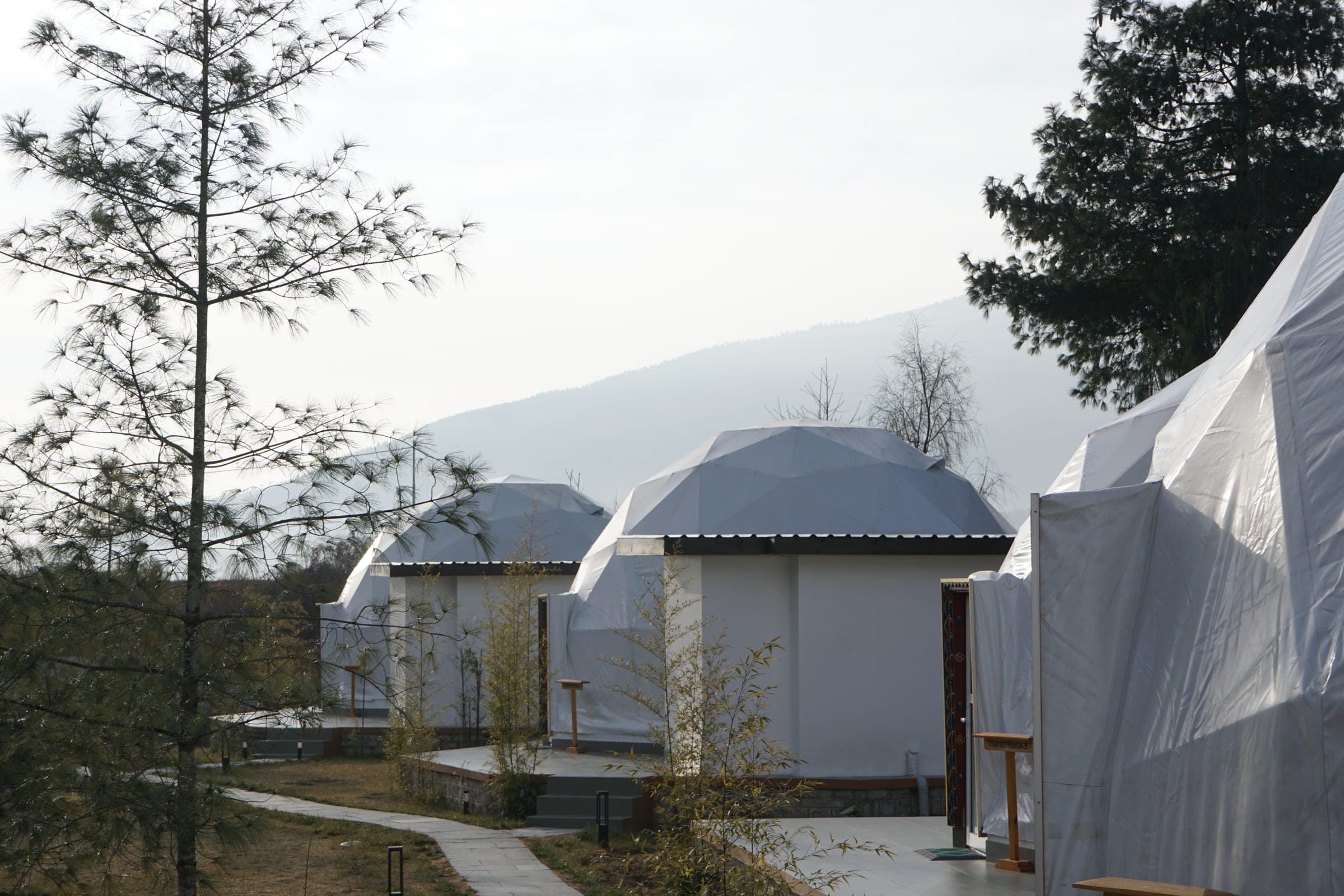 Riverfront glamping domes on a misty mountain morning at Highland Glamping, Paro